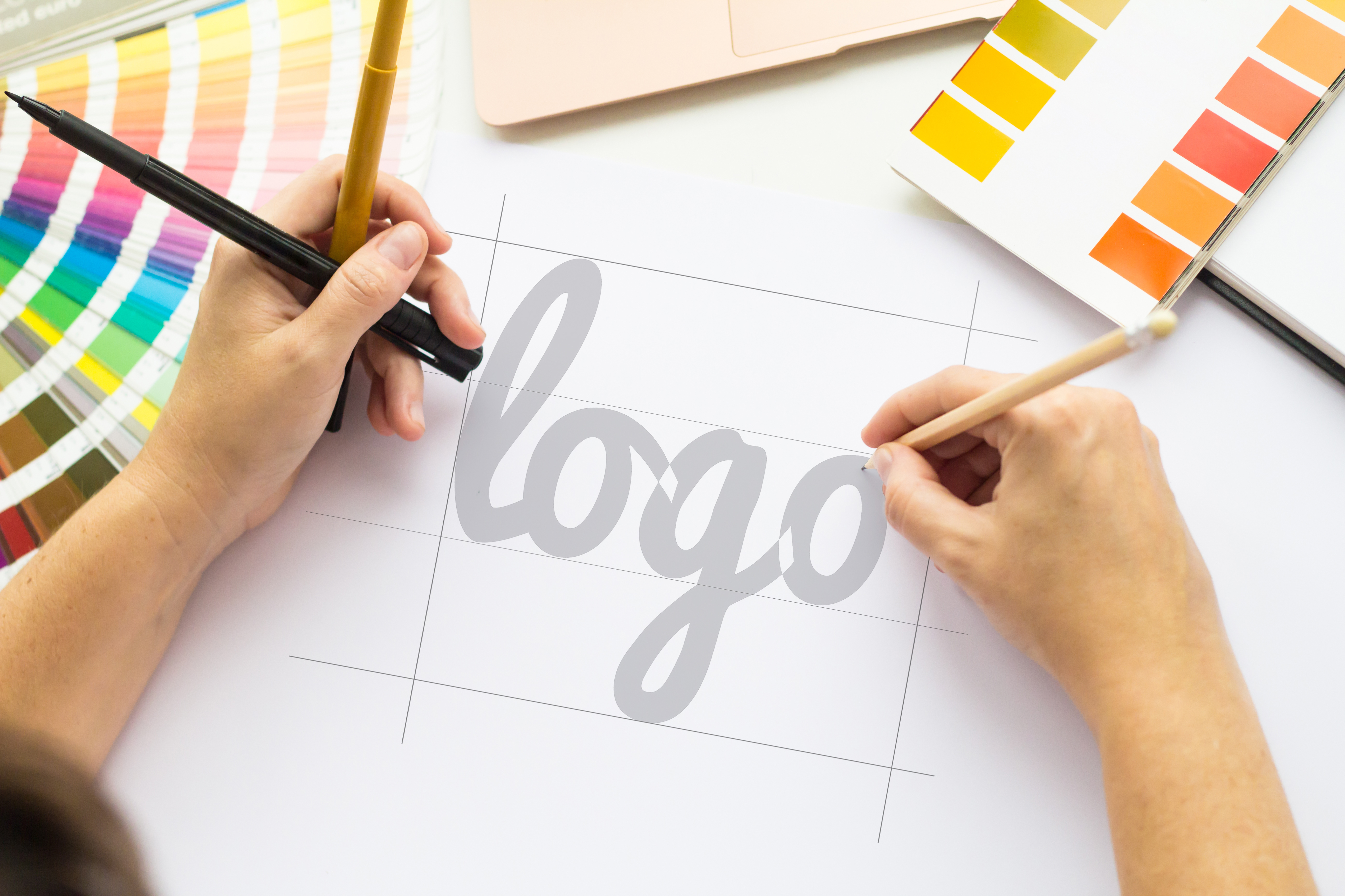 Hands Drawing a Logo